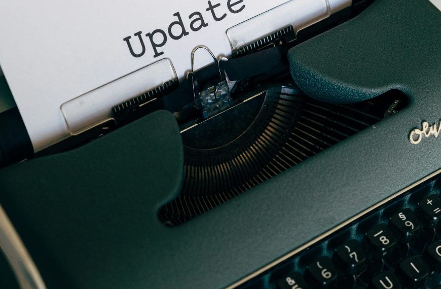 A close-up of a vintage typewriter with paper displaying the word 'Update'.